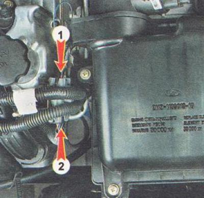 3. Disconnect the connectors (1 and 2) of the injector wiring harness.