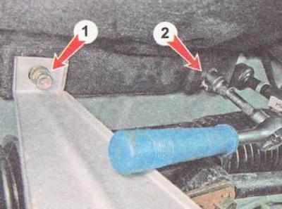7. Using a 10 mm socket wrench, unscrew the nut (1) of the upper fastening of the protective screen…