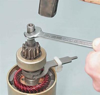10. With a hammer through an open-end wrench by 13 mm knock down the starter drive travel limiter…