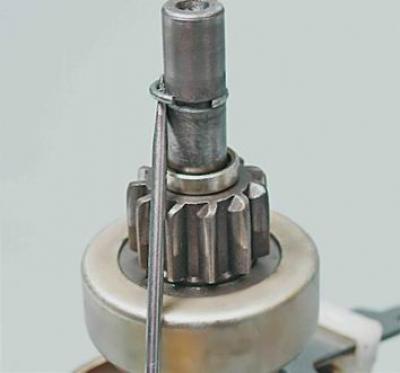 11. Using a slotted screwdriver, remove the drive travel limiter retaining ring from the groove in…