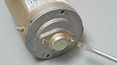 15. Using a Phillips screwdriver, unscrew the two screws securing the cap.
