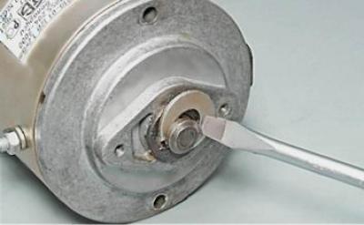 17. Using a slotted screwdriver, pry up and remove the retaining ring.