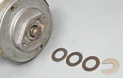 18. Remove the adjusting washers from the shaft.