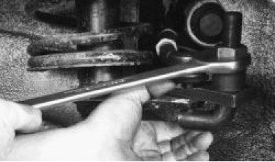 7. Loosen the bolts securing both steering rods to the steering gear by bending back the ends of…