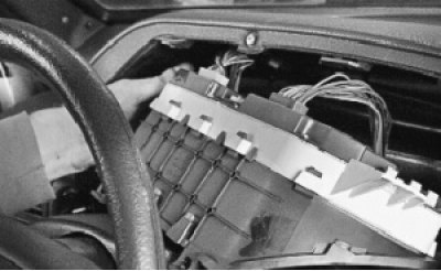 5. Disconnect the wiring harness connectors from the instrument cluster and remove it.