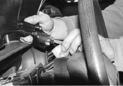 4. Turn the switch until one of the latches matches the slot in the trim, squeeze