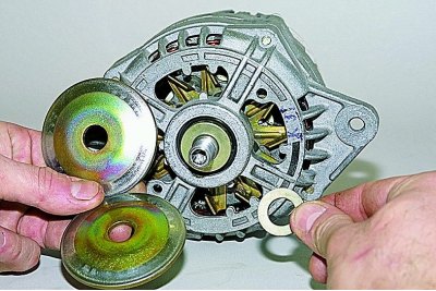 Using a 21 mm open-end wrench, loosen the pulley mounting nut while holding the rotor with an 8 mm…