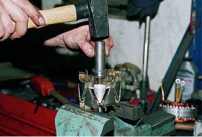 Using a puller, we press the bearing off the rotor shaft.