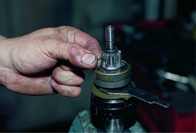 We pry off the locking ring with a screwdriver..