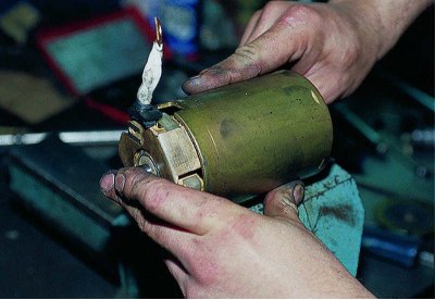 Before installing the brush holder on the armature collector, remove all four springs so that the…